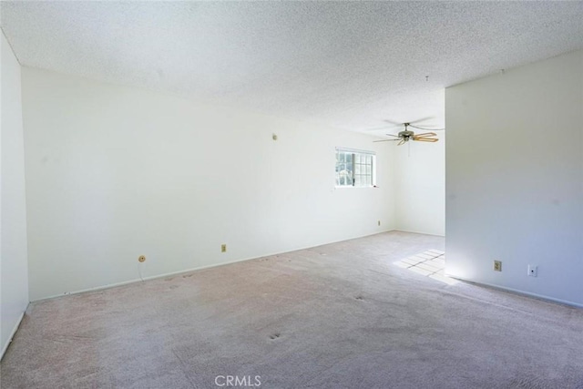 unfurnished room featuring light carpet, ceiling fan, and a textured ceiling