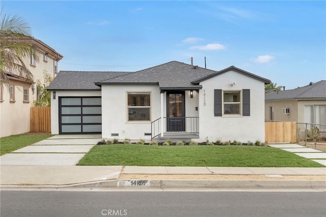 view of front of home with a garage and a front lawn