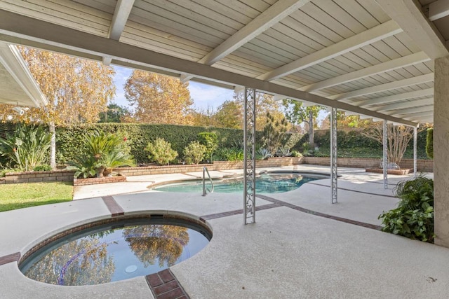 view of pool featuring a patio area and an in ground hot tub