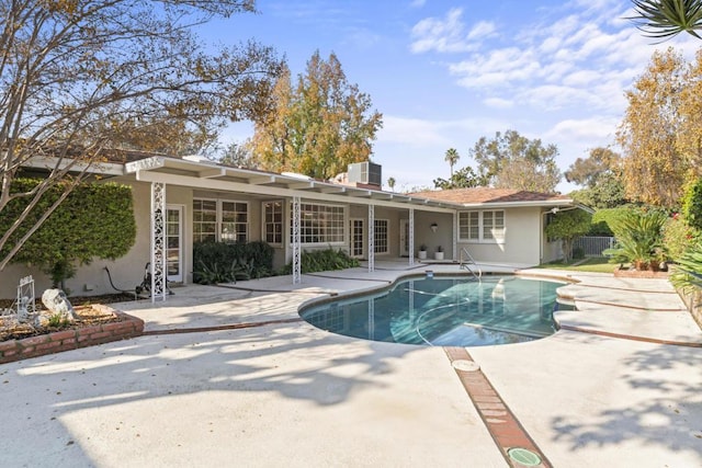 view of pool featuring a patio and central AC