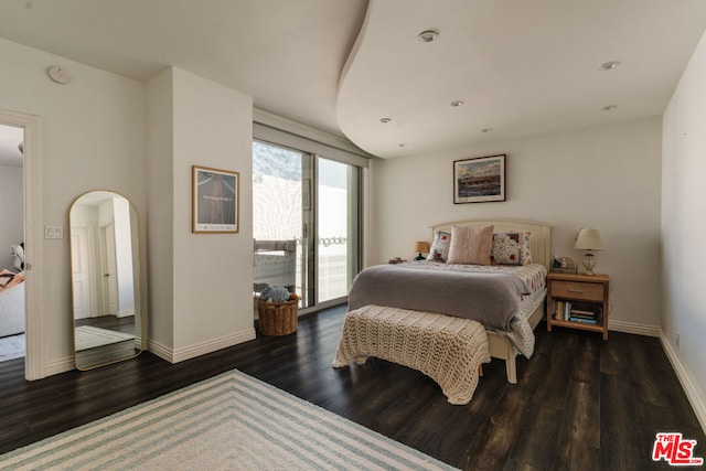 bedroom featuring access to exterior and dark hardwood / wood-style floors