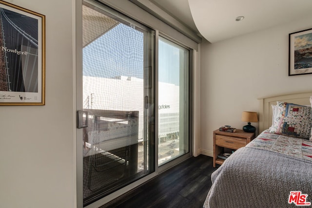 bedroom featuring dark hardwood / wood-style flooring and access to outside