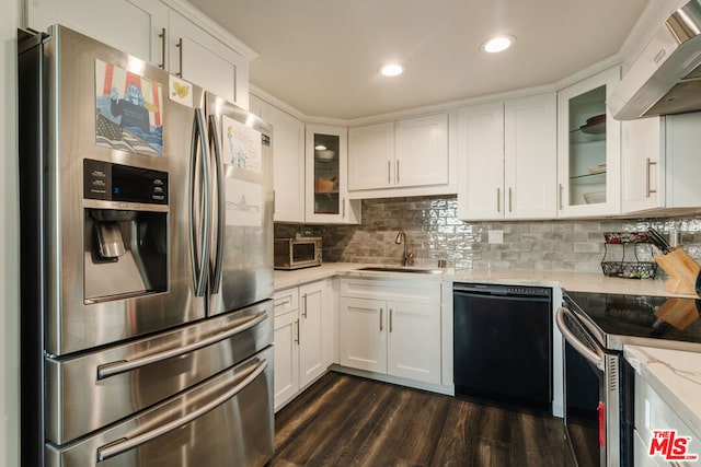 kitchen featuring wall chimney exhaust hood, appliances with stainless steel finishes, sink, and white cabinets