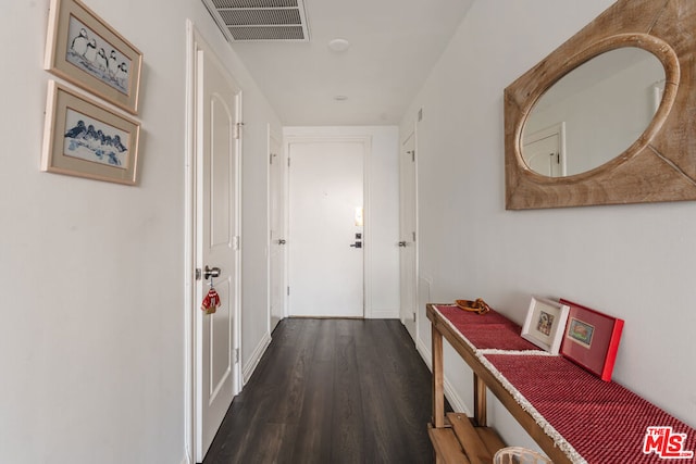 corridor with dark hardwood / wood-style flooring