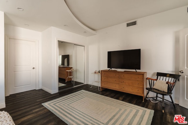 bedroom featuring dark hardwood / wood-style flooring and a closet