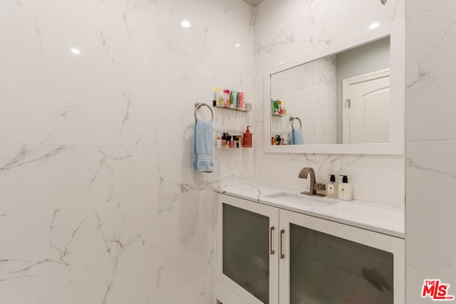 bathroom featuring vanity and tasteful backsplash