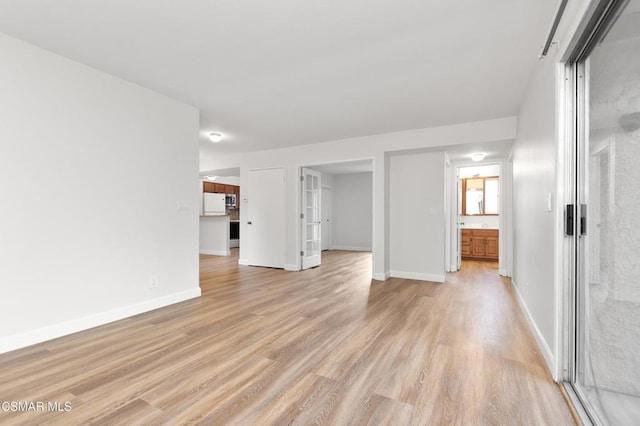 unfurnished living room with light hardwood / wood-style floors