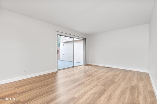 spare room with light hardwood / wood-style flooring