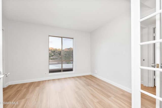 spare room with light wood-type flooring