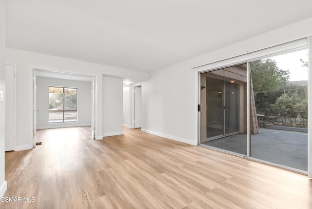 unfurnished living room with light wood-type flooring