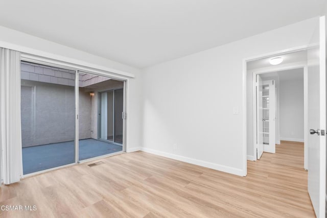 spare room featuring light wood-type flooring