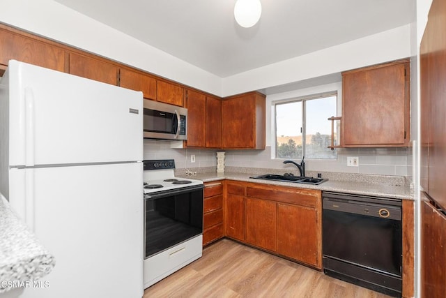 kitchen with sink, light hardwood / wood-style flooring, black dishwasher, white fridge, and electric stove