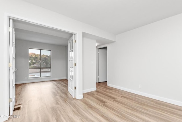 spare room featuring light hardwood / wood-style flooring