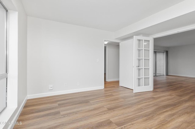 spare room featuring light hardwood / wood-style floors