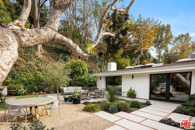 rear view of house with an outdoor hangout area and a patio