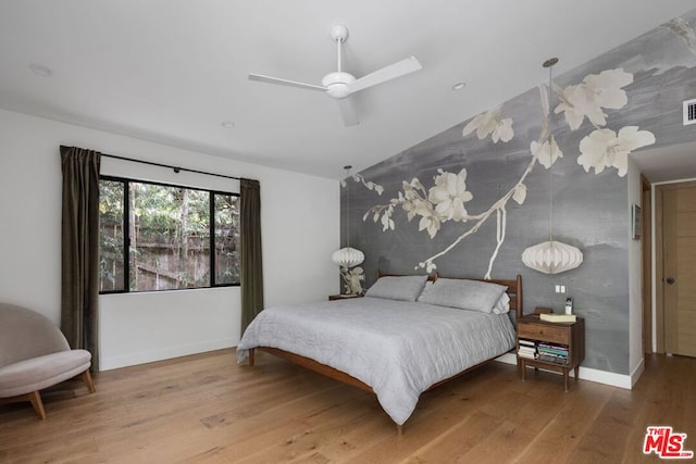 bedroom featuring vaulted ceiling, hardwood / wood-style floors, and ceiling fan