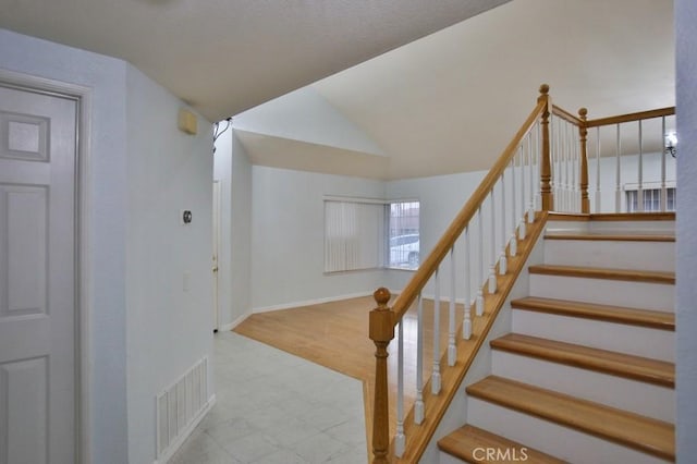 stairs featuring lofted ceiling