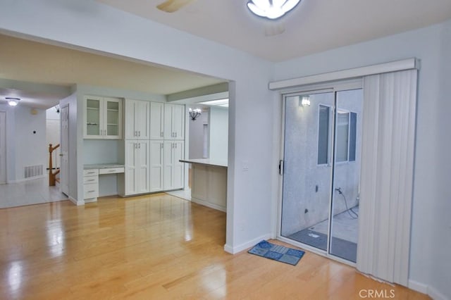 entrance foyer featuring ceiling fan and light wood-type flooring