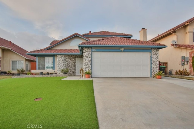 mediterranean / spanish home featuring a garage and a front yard