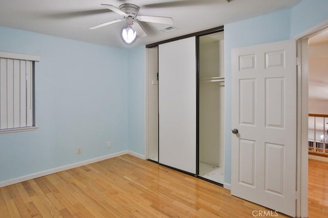 unfurnished bedroom featuring a closet, ceiling fan, and light wood-type flooring