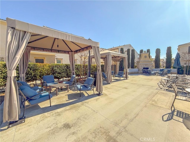 view of patio / terrace with a gazebo and exterior fireplace