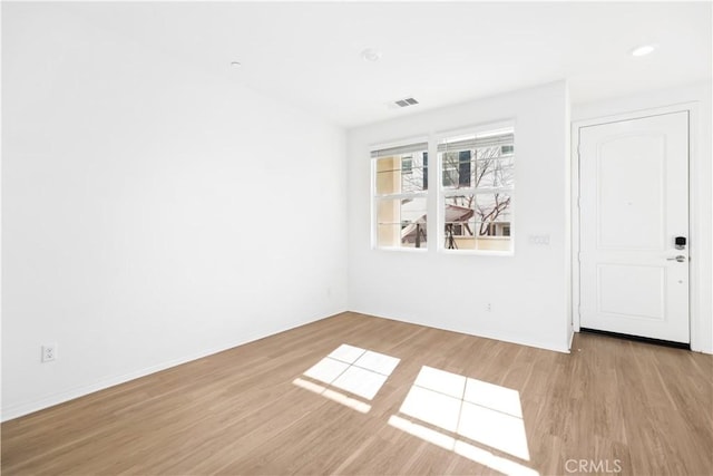 spare room featuring light hardwood / wood-style floors