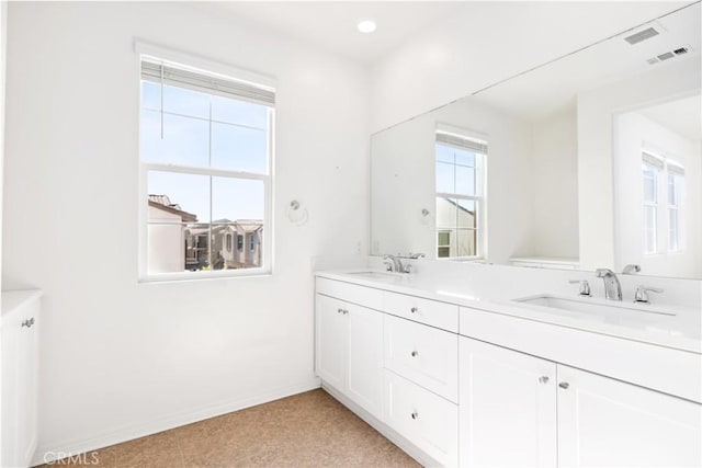 bathroom featuring a healthy amount of sunlight and vanity