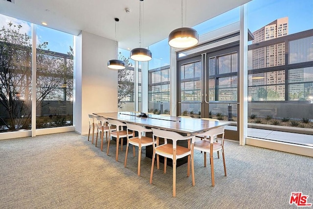 carpeted dining space featuring a wall of windows