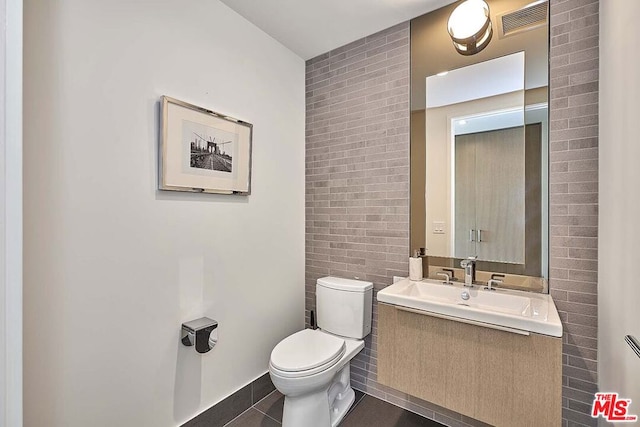 bathroom with tile patterned floors, toilet, and vanity