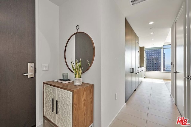 corridor featuring light tile patterned flooring