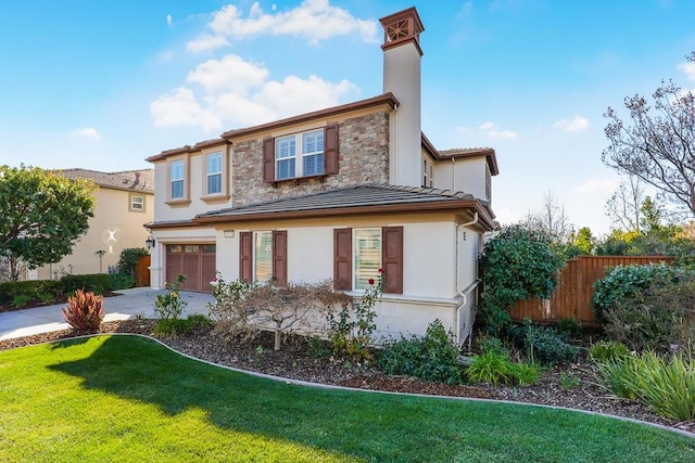 view of front of house with a garage and a front yard