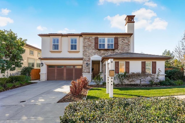 view of front of home with a garage and a front lawn