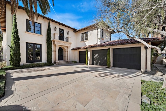 mediterranean / spanish home with a garage