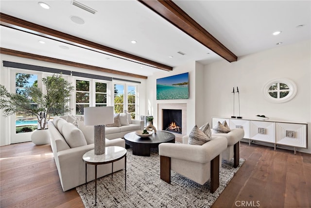 living room with beam ceiling and hardwood / wood-style flooring