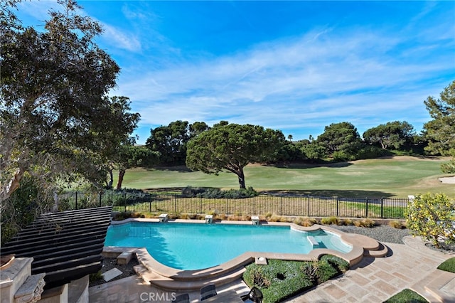 view of pool featuring a patio, a yard, and a diving board