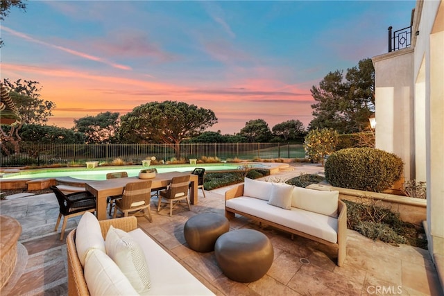 patio terrace at dusk featuring an outdoor hangout area