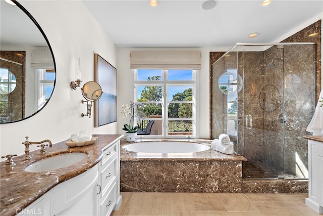 bathroom featuring vanity and independent shower and bath