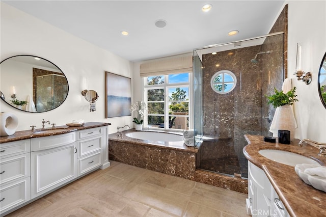 bathroom featuring vanity and shower with separate bathtub