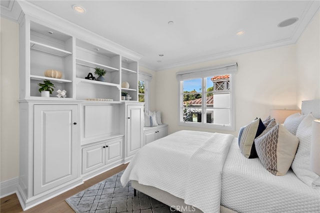 bedroom with crown molding and dark hardwood / wood-style flooring