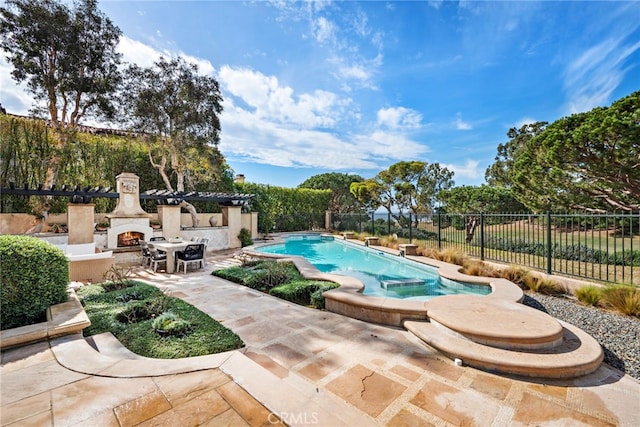 view of swimming pool featuring exterior fireplace and a patio area