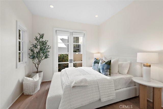 bedroom with dark wood-type flooring and french doors