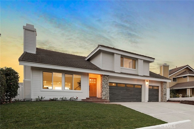 view of front facade featuring a yard and a garage