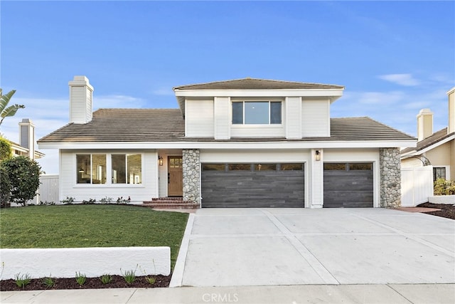 view of front of home with a garage and a front yard