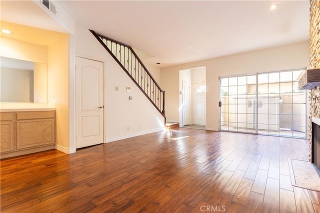 unfurnished living room with a fireplace and hardwood / wood-style floors