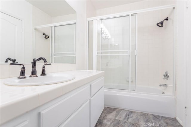 bathroom with vanity and bath / shower combo with glass door