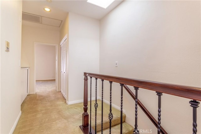 corridor with light colored carpet