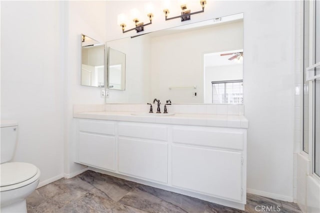 full bathroom with ceiling fan, enclosed tub / shower combo, vanity, and toilet