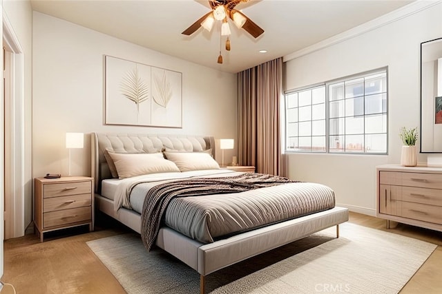 bedroom with ceiling fan and light hardwood / wood-style flooring