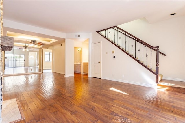 unfurnished living room featuring hardwood / wood-style flooring and ceiling fan