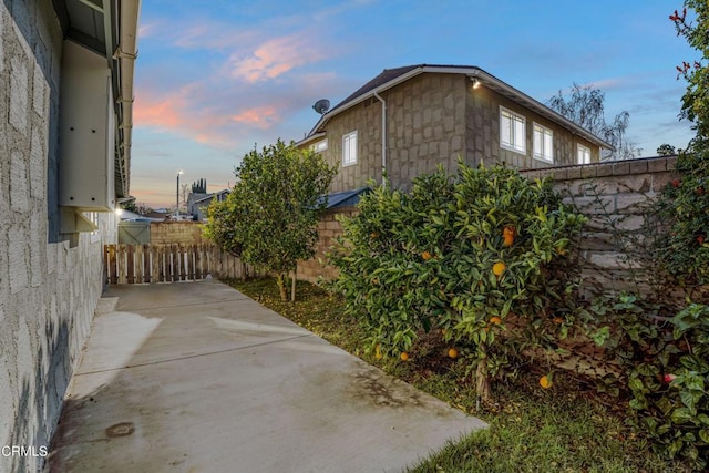 property exterior at dusk with a patio